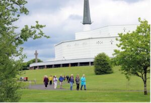 Visitors to Knock Shrine walk through the grounds. (Sinead Mallee)