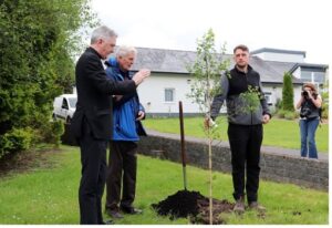 Jesuit Fr. Brian Grogan, wearing a blue coat, participates in a tree planting at the Creation Walk at Knock Shrine. Also pictured is Fr. Richard Gibbons, left, rector of Knock Shrine, and horticulturalist Dylan Prendergast. (Sinead Mallee)